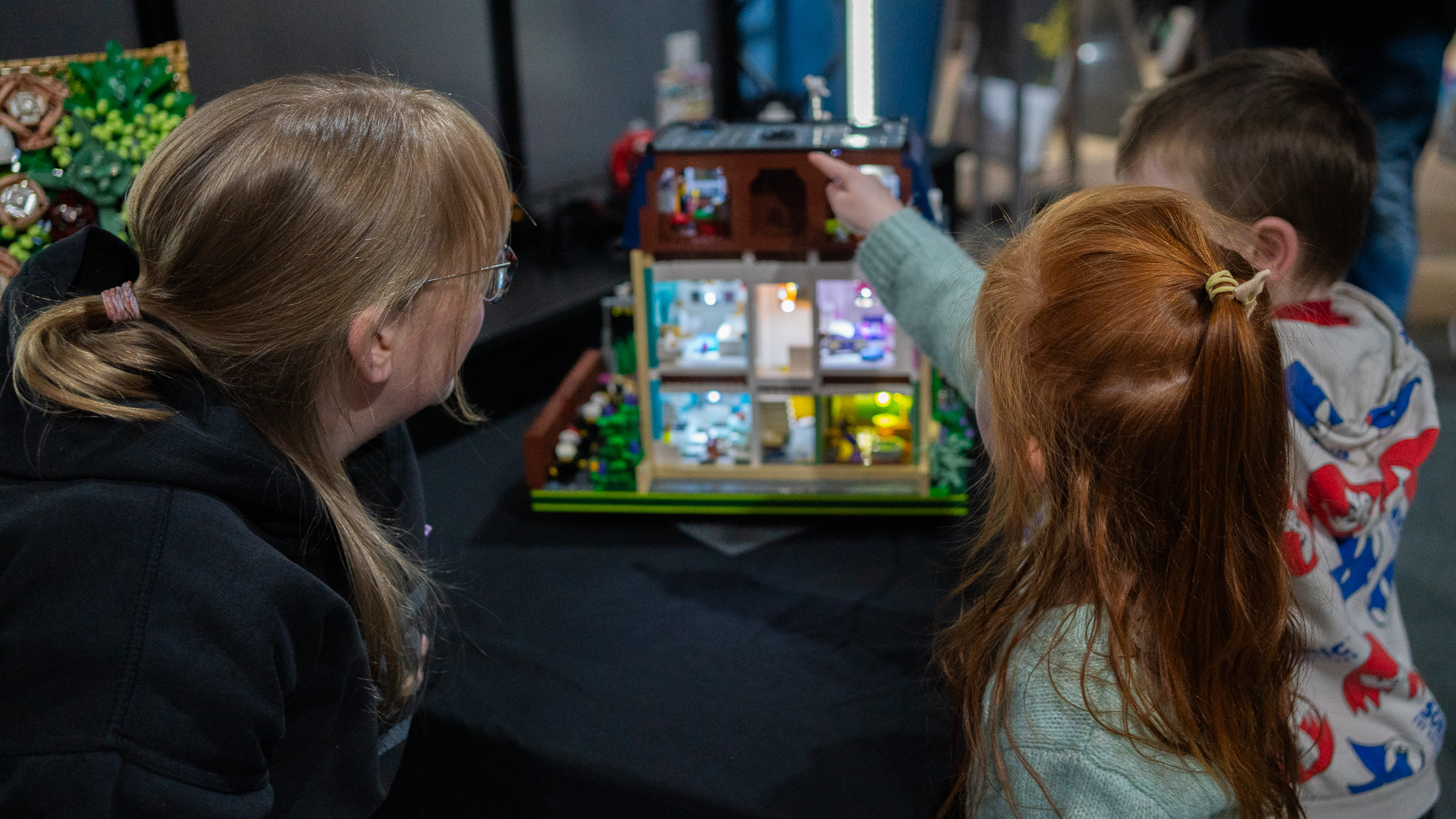Mother and two young children looking at a LEGO display at Brickish Weekend