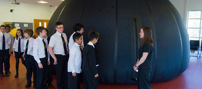 Children lined up, waiting to enter an inflated Star Dome.