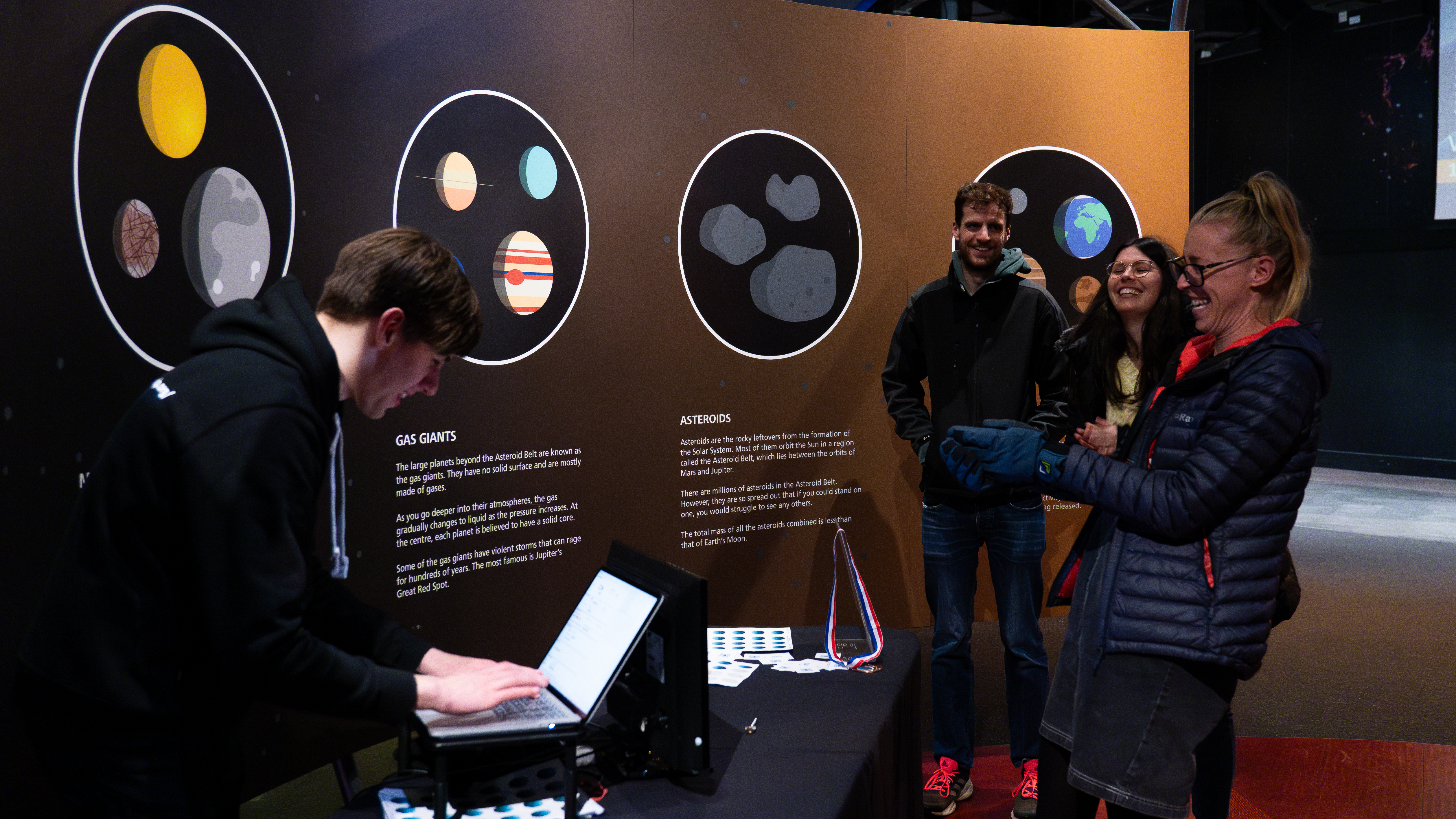 Adults engaging with science experiment at Space Lates