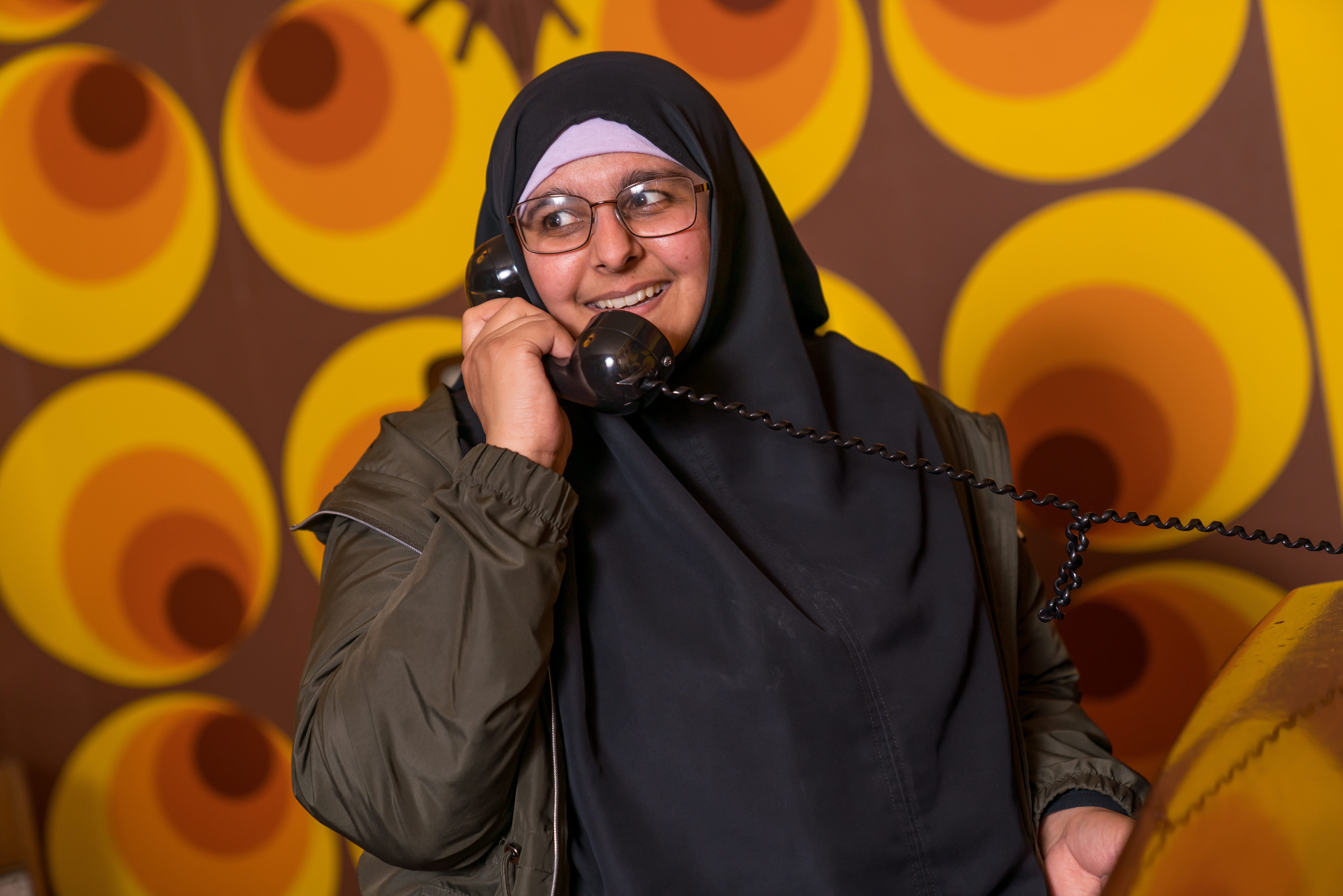 Lady on the phone in the 1969 sitting room in the Rocket Tower