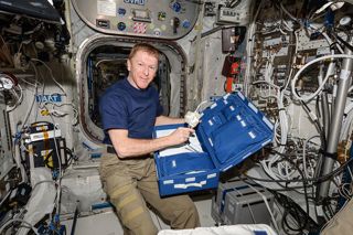 ISS 47 Tim Peake Unpacks An Analyzer In The Columbus Module