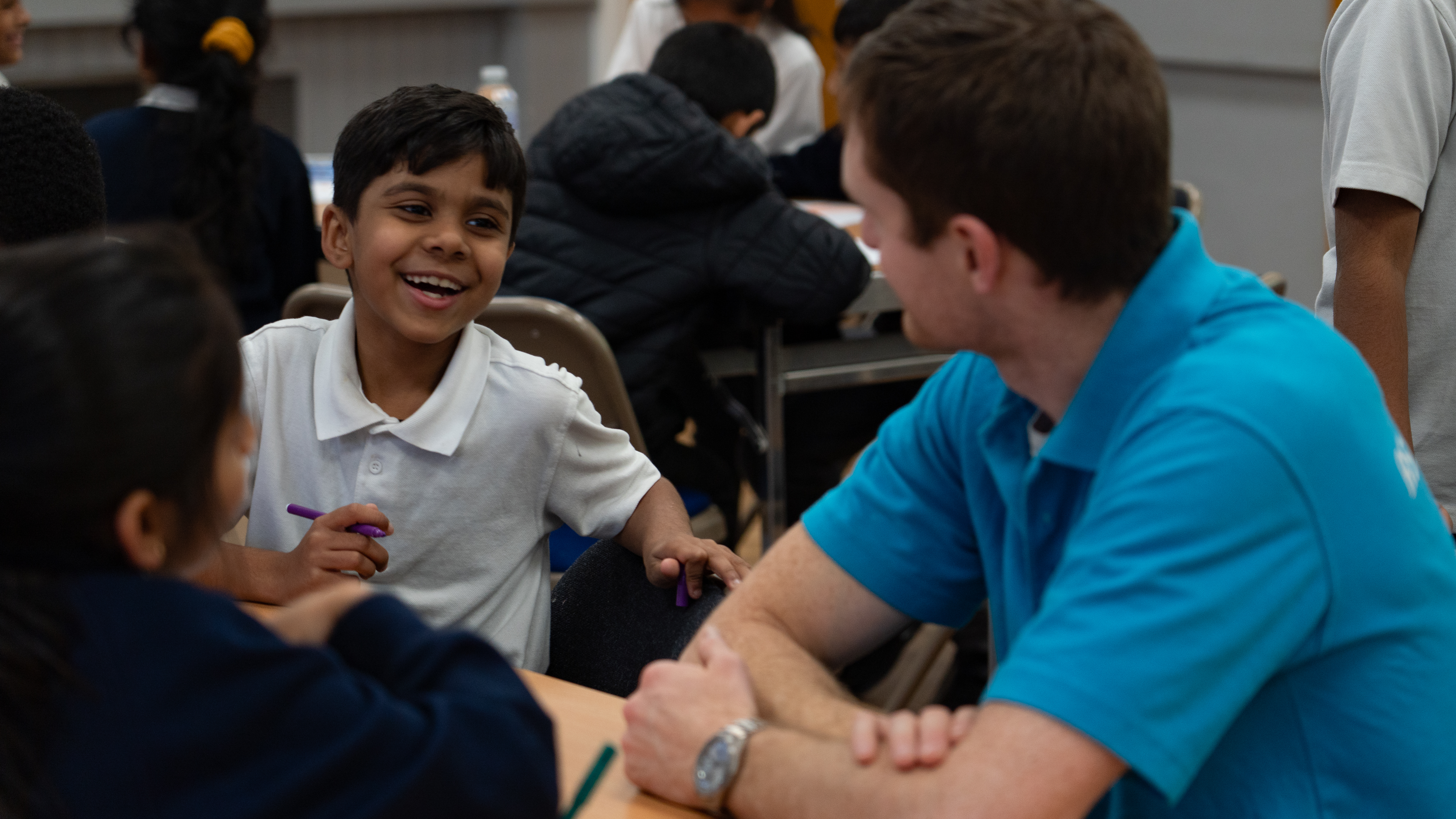 Community team at an After School Club with a happy child