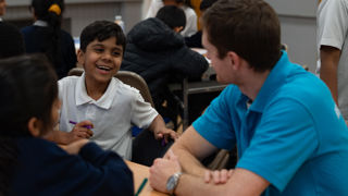 Community team at an After School Club with a happy child