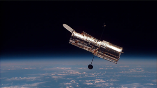 The Hubble Space Telescope in orbit above Earth.