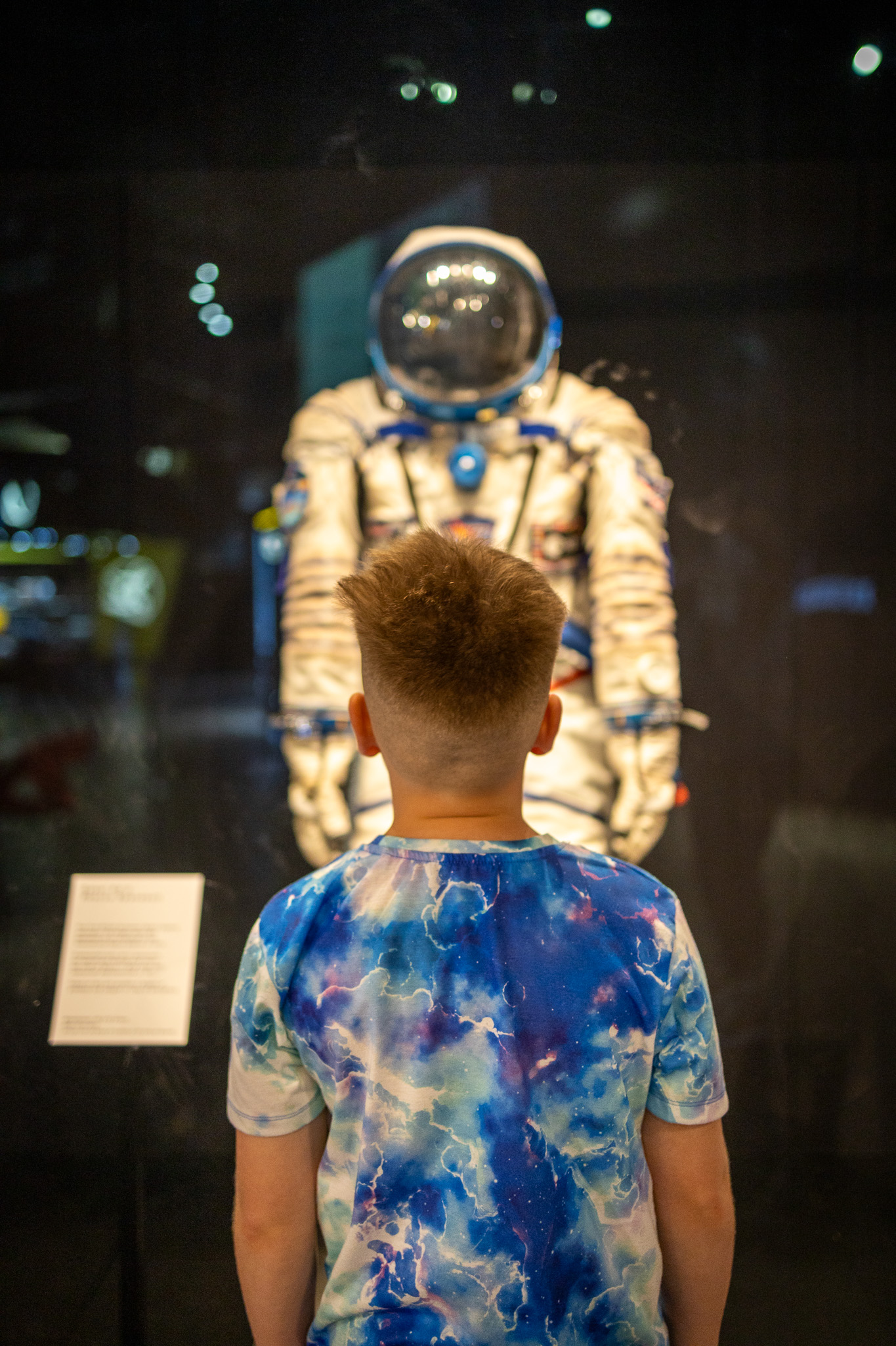 Child looking at Tim Peake spacesuit in Welcome Hall