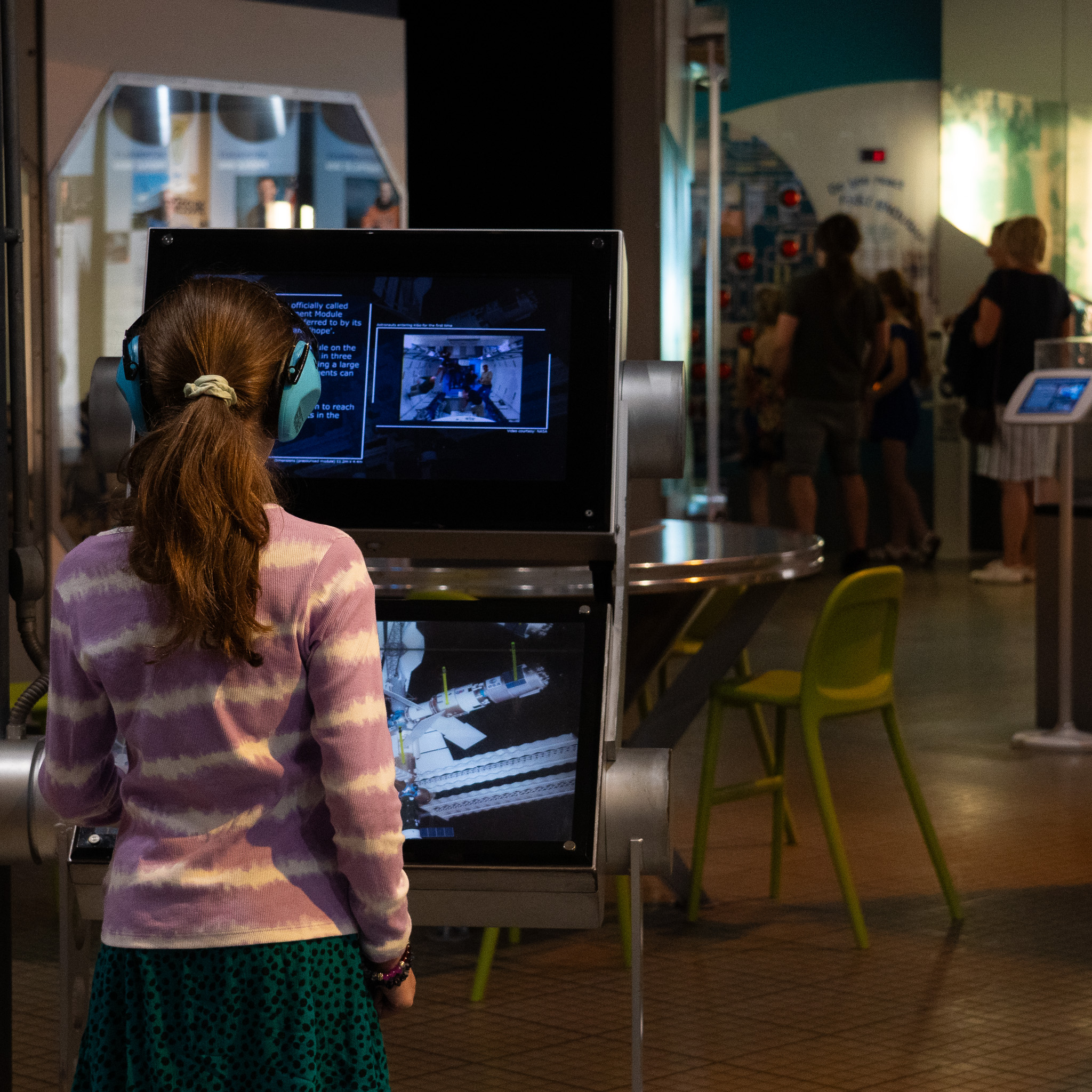 Child with ear defenders in Into Space gallery at Accessible Afternoon