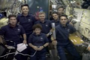 The crew of mission STS 78 with the Atlanta Olympic Torch onboard the Space Shuttle Columbia.