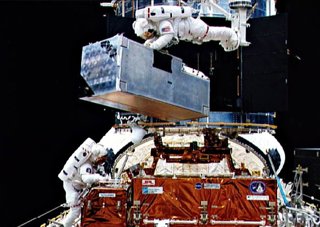 COSTAR is being installed onto the Hubble Space Telescope by astronauts.