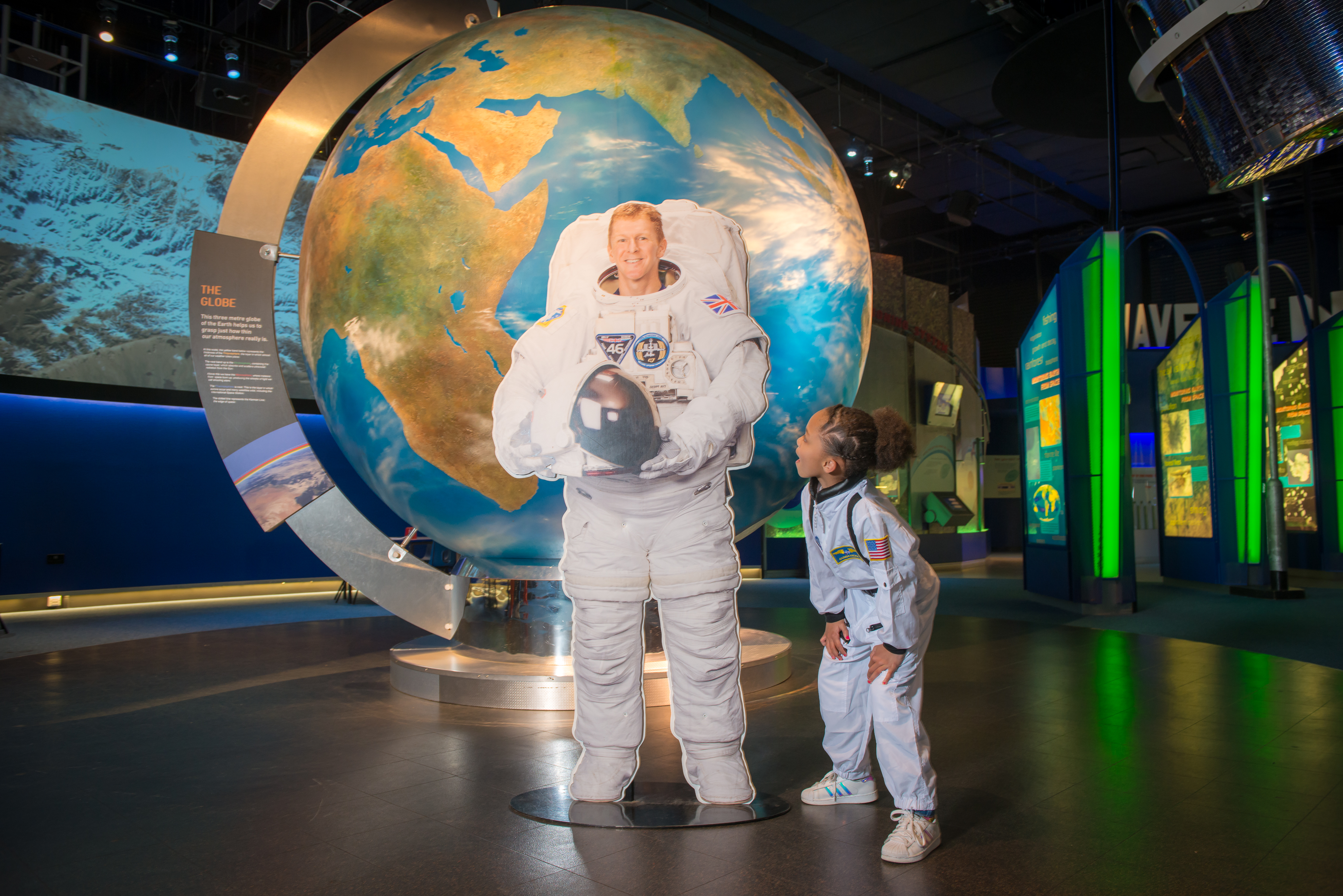 Child in a spacesuit with Tim Peake