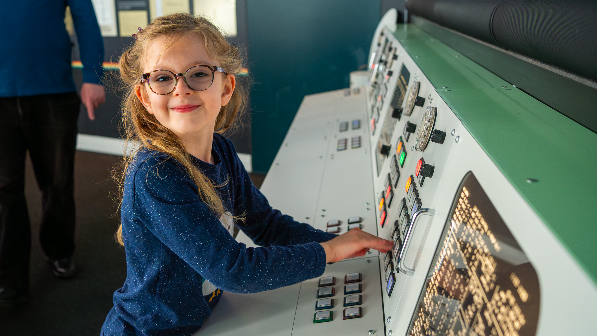 Child interacting with mission control desk in Britain's Space Race gallery in the Rocket Tower
