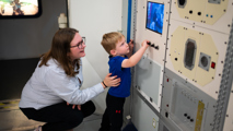 Young boy and mother in the Columbus Module in Into Space