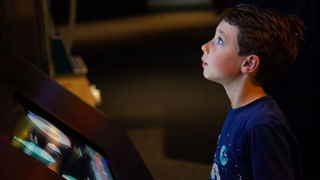 Child interacting with Power of 10 exhibit in The Universe gallery