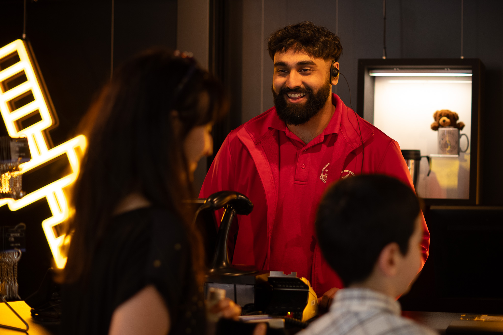 Space Crew serving a family in the shop