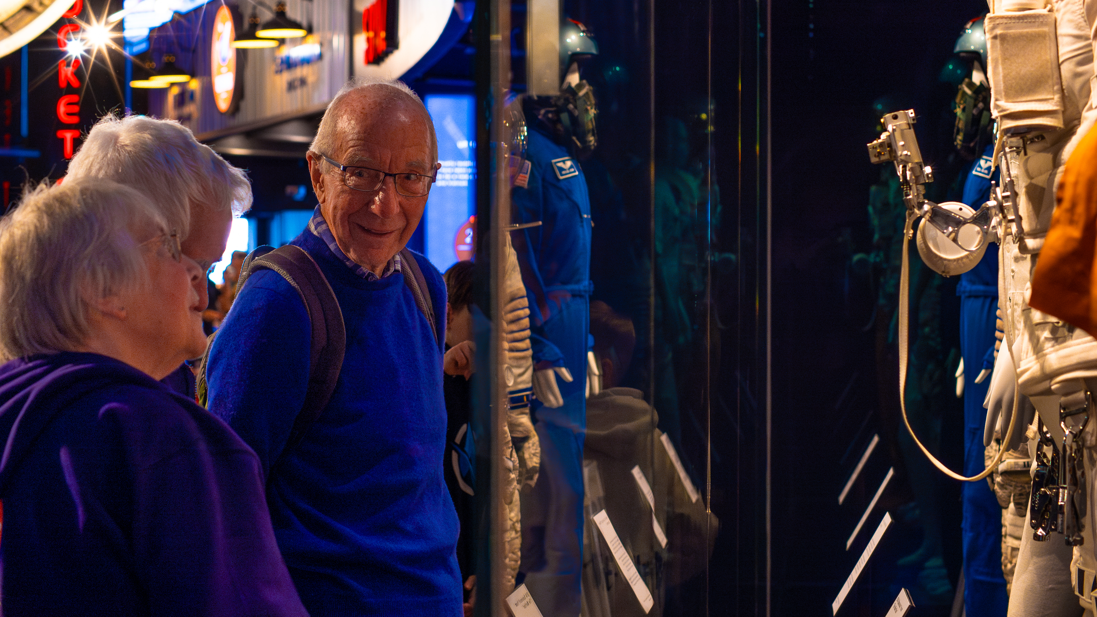 Group of older visitors looking at the spacesuit display in the welcome hall