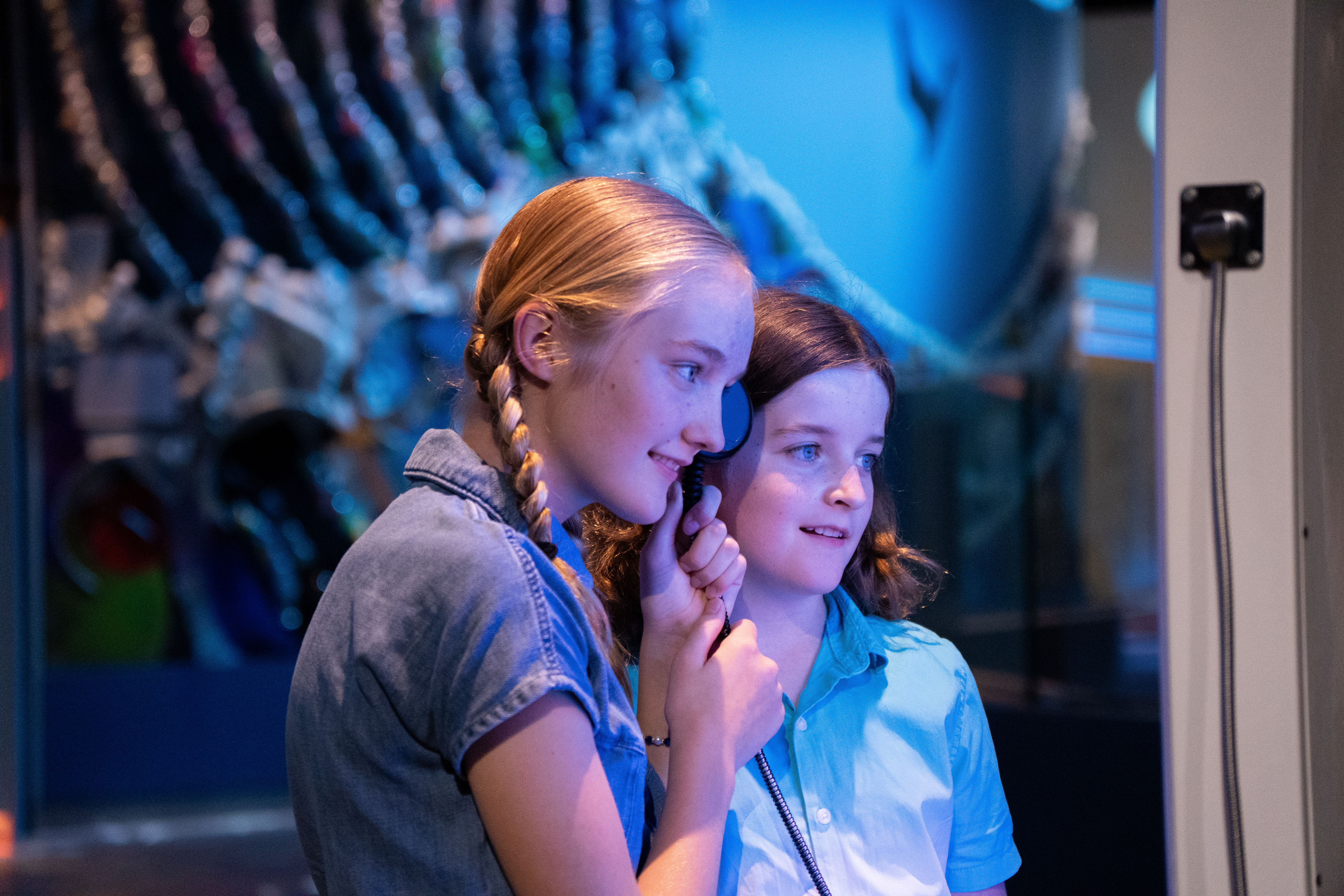 Two children watching their video in the Home Planet gallery 