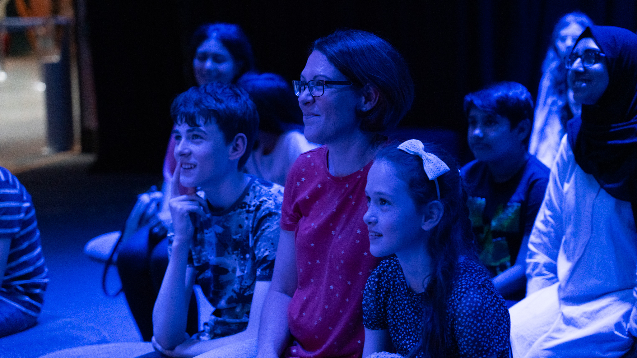 Families happily engaging in a talk/demonstration in LIVE Space