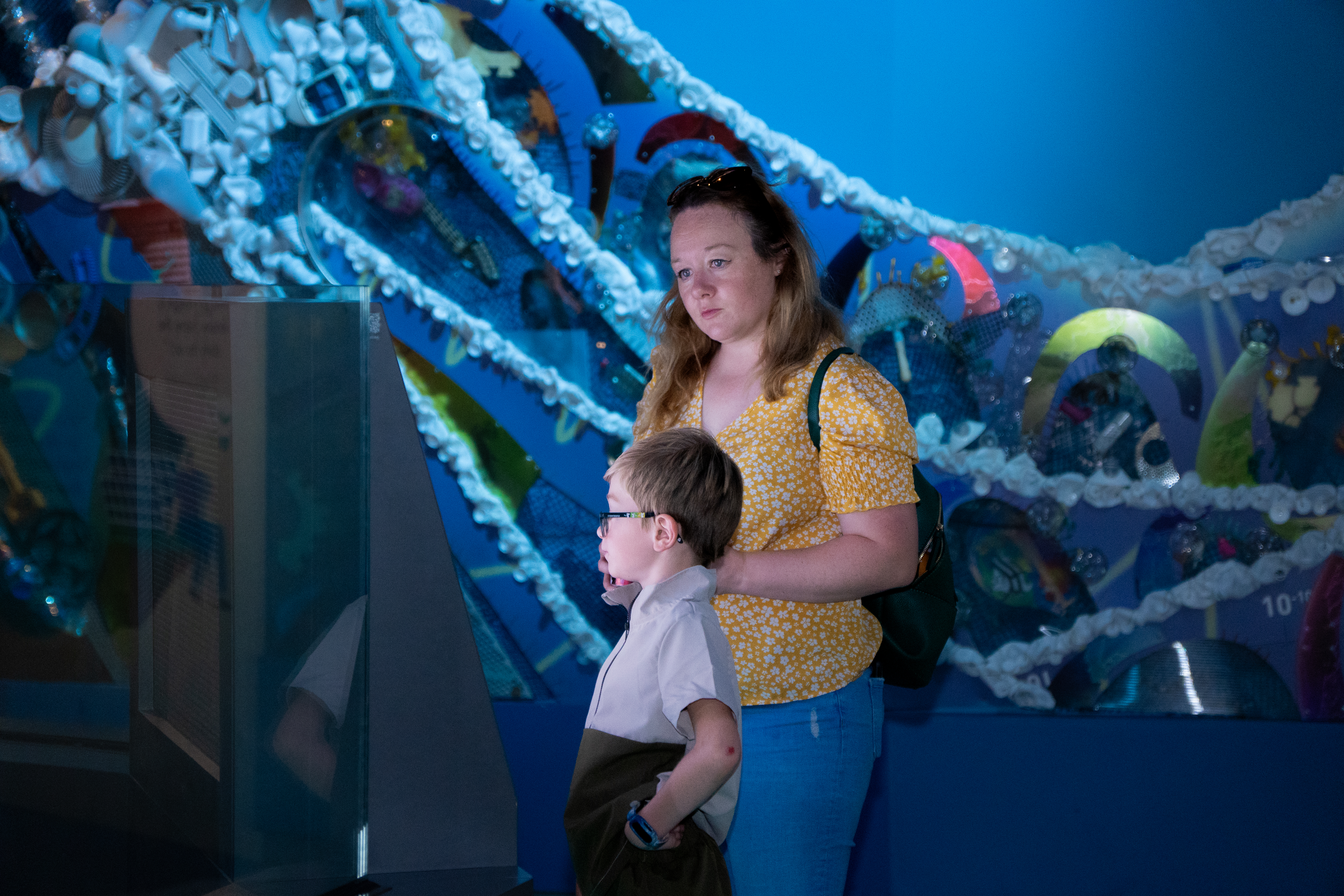 Mother and child reading information in the Home Planet gallery