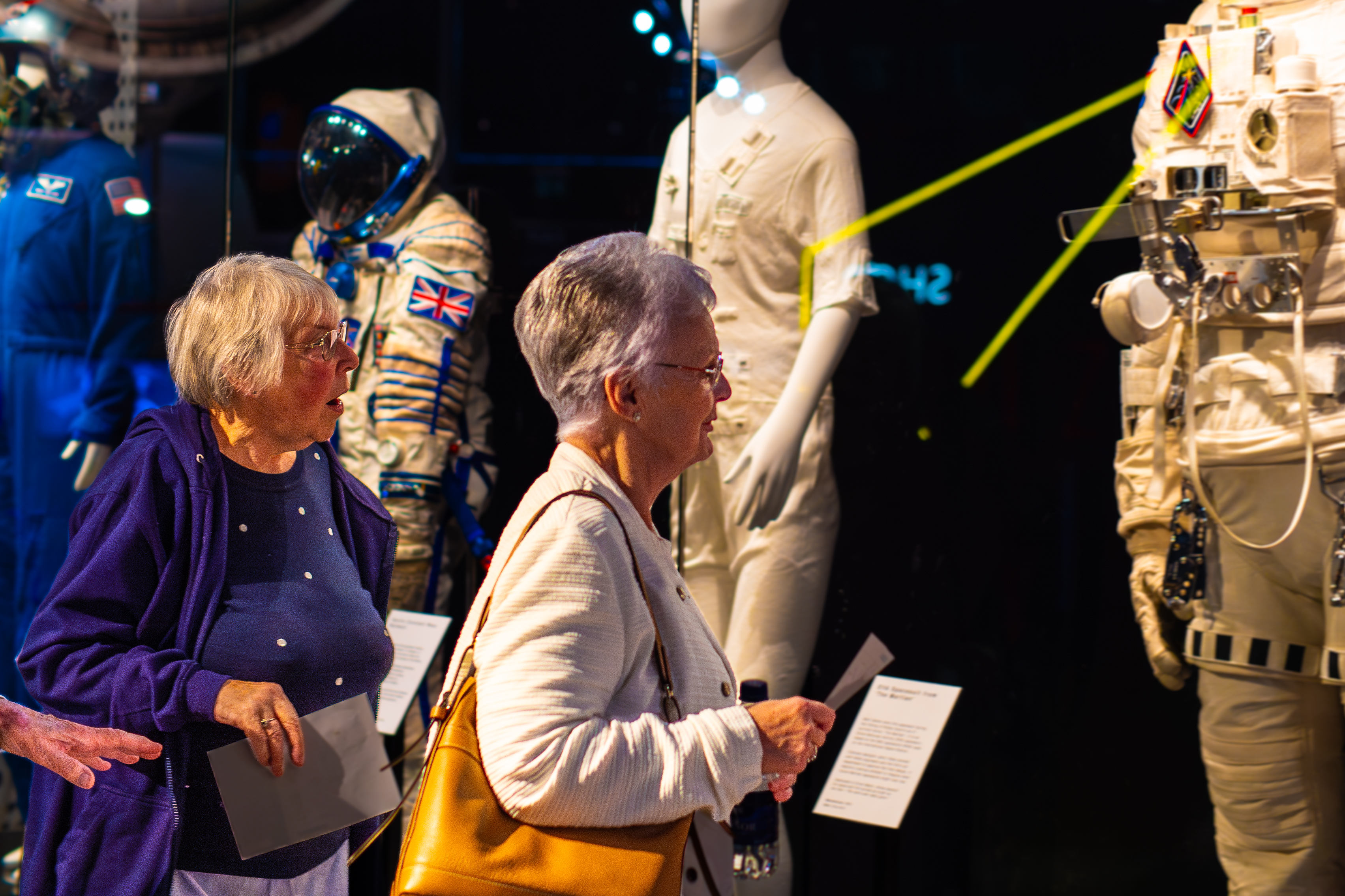 Two older ladies looking at the spacesuit display in the welcome hall