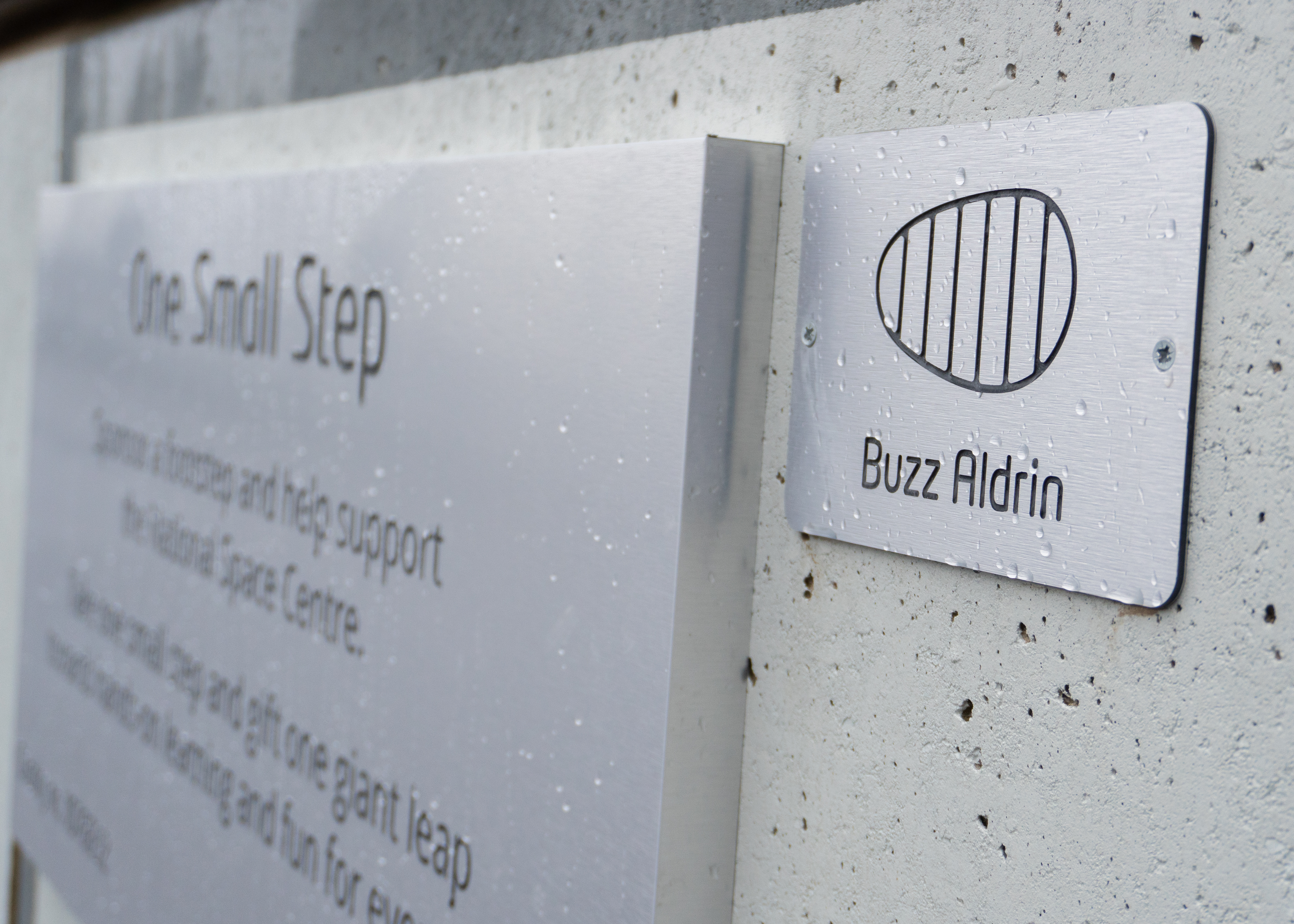 A footstep sponsorship panel for Buzz Aldrin with the information panel
